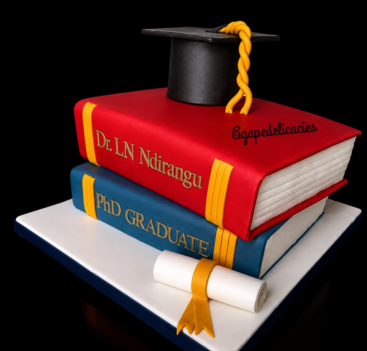Graduation cake with academic books and cap
